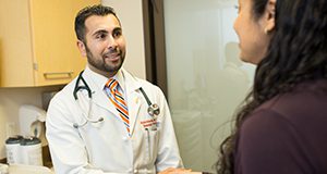 a photo of a doctor talking with a patient