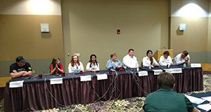 9 youth dairy quiz bowl competitiors seated in a row at table with buzzers and wiring