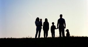 family sillouhetted against horizon