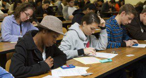 Students in a classroom taking a test.