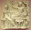 Grave relief showing the deceased and his widow in a funeral feast where they are depicted in a godlike manner. Roman marble work, 1st century AD.