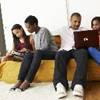 A family sitting on a couch.