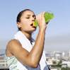 A young woman drinking an energy drink.