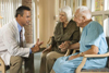 An elderly couple talking with a doctor.