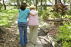 An older woman and younger woman on a walk.