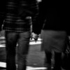 Black and white photo of a man and woman holding hands.