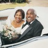 An older couple wearing a wedding dress and tuxedo.