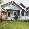 A child running in yard with a toy plane.