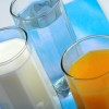 Glasses of milk, water, and orange juice.