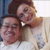 An older couple smiling together.