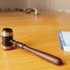 A gavel laying on a table.