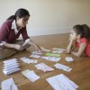 A woman and her child sorting bills.