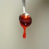 Spoonful of fruit juice thickened to honey-like thickness.