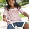 A little girl on a bike.