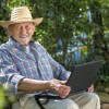 An elderly man with a laptop.