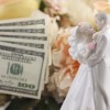 Money next to a wedding cake topper.