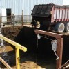 Manure and bedding mixture being loaded into a mixed plug-flow anaerobic digester