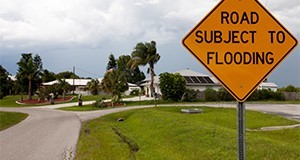 Street sign cautions, road subject to flooding