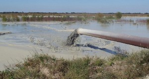 Inlet pipe depositing sand-clay mix.