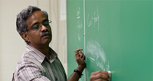 Horticulture Professor Balasubramanian Rathinasabapathi (Saba) writing on a chalkboard.