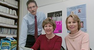 Ron Lutz, left, Gail Rampersaud, and Lynn Bailey reviewing educational materials developed by the Florida Folic Acid Coalition to promote awareness about the health benefits of the vitamin.