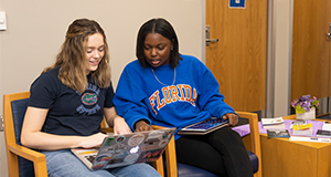 Two students look at a laptop screen. UF/IFAS Photo by Cat Wofford.