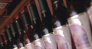 Several wine bottles of the same brand organized in a single line with the label facing out.