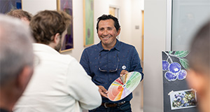 Patricio Muñoz (middle) presenting to a group about blueberries in the lab. Photo taken 04-05-24. UF/IFAS Photo by Tyler Jones.