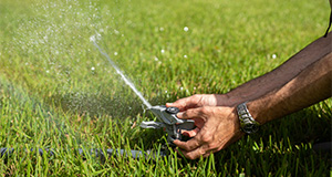 Hands manipulating a lawn sprinkler. Photo taken 09-22-20. UF/IFAS Photo by Cristina Carrizosa.