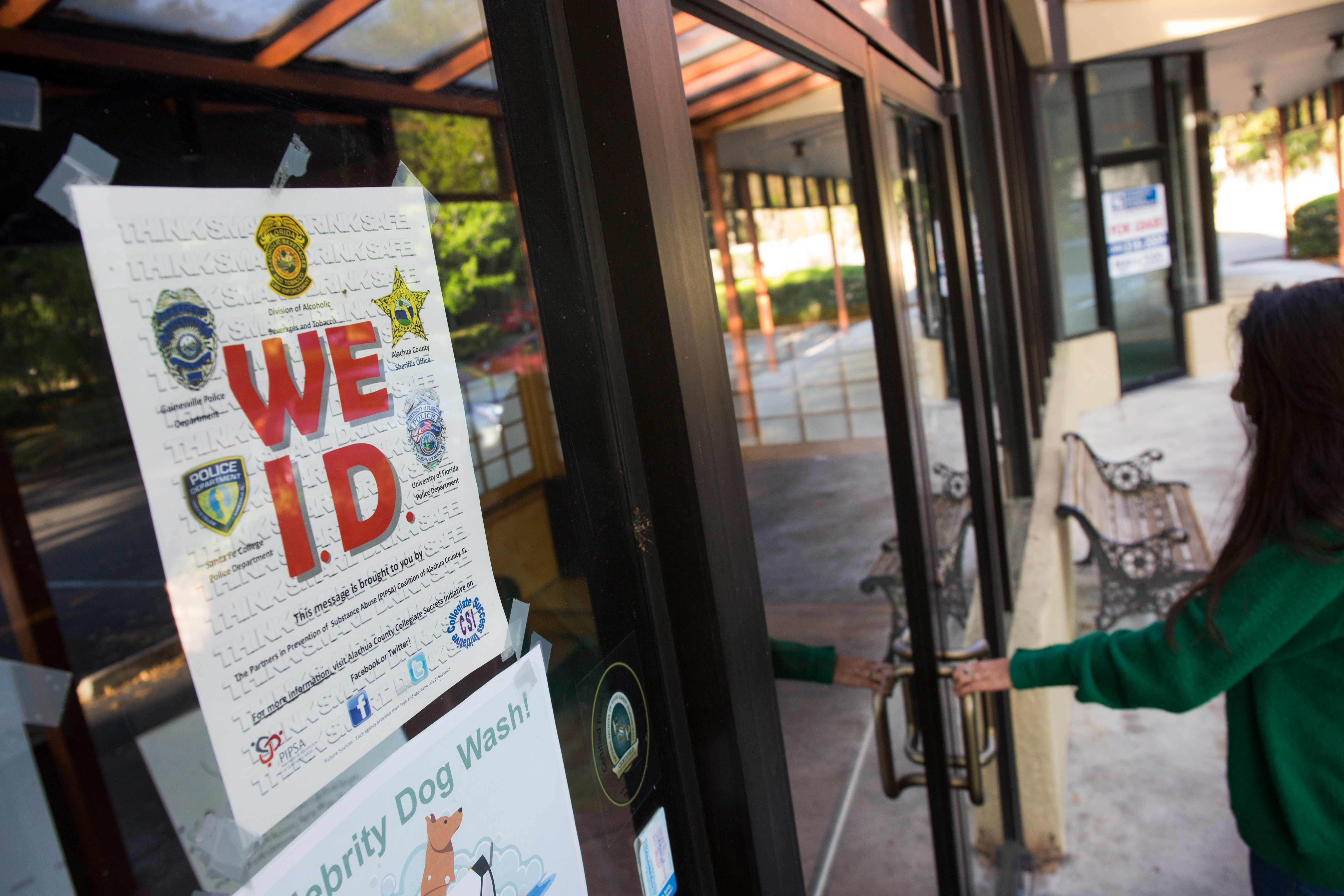 We ID sign to prevent underage alcohol consumption posted on a storefront. Photo taken 03-28-17. UF/IFAS Photo by Tyler Jones.